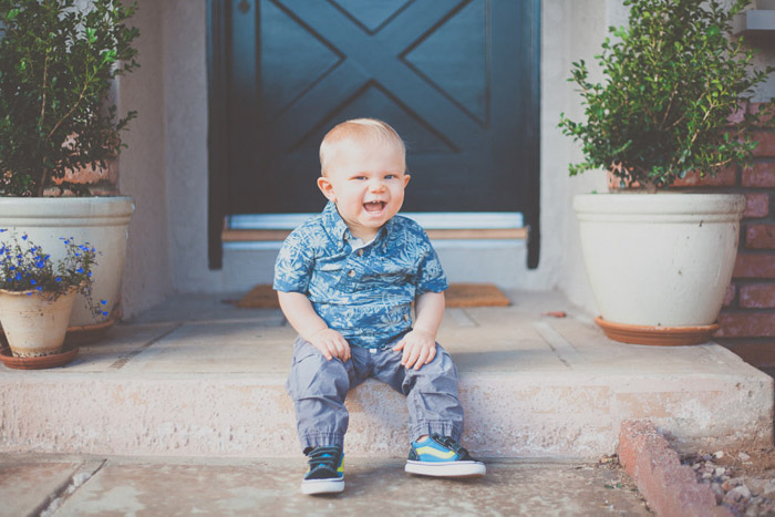 A baby boy sitting on an outdoor step - children photography