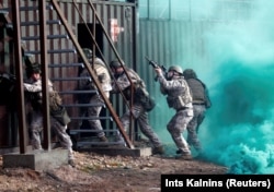 Latvian Army soldiers practice urban fighting during Silver Arrow 2017 multinational military drills involving eleven NATO members in Adazi, Latvia October 29, 2017.