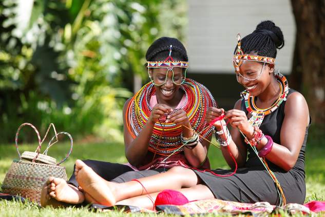 Adolescent girls talking and crafting together in Kenya
