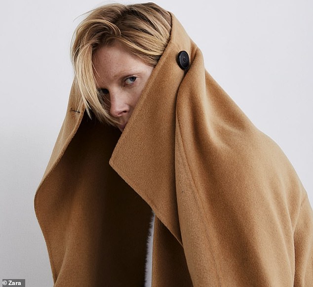 A model took this £119 coat which features a wraparound collar quite literally, tugging it high over her head