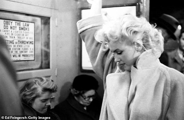 Marilyn takes the subway - no one  seems to have noticed the Hollywood starlet in the car