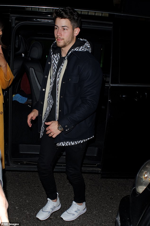 Casual: Meanwhile, Nick opted for a more casual look, sporting a geometric print hooded jacket with a pair of black jeans and sparkling white trainers