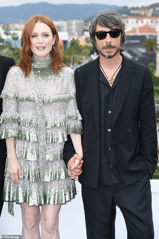 Support: The stunning redhead held hands with designer Pierpaolo Piccioli, creative director at Valentino, who worked on the movie with screenwriter Michael Mitnick