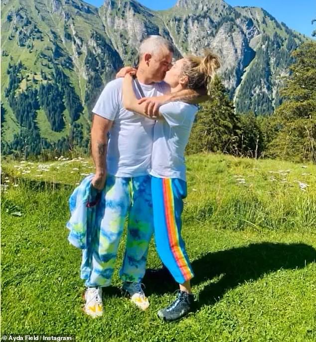 In Love: Robbie Williams and Ayda Field shared a kiss in celebration of their ten year wedding anniversary on Friday despite postponing their wedding vow renewal due to COVID-19