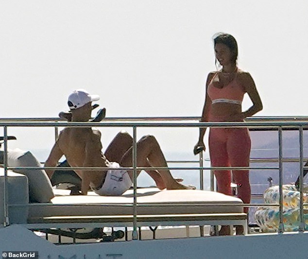 Soaking up the sun: Cristiano Ronaldo, 35, and Georgina Rodriguez, 26, appeared to be in good spirits as they relaxed on his £5.5m yacht in Savona, Italy, on Sunday