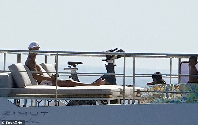 Taking in the view: Ronaldo went shirtless as he worked on his tan on Sunday