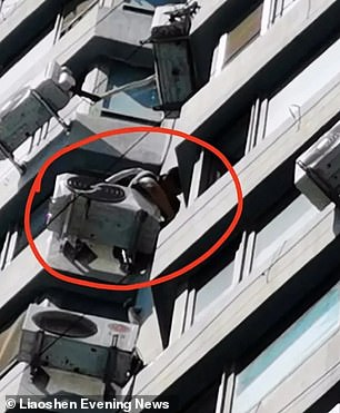 The picture reportedly shows the air-con installer looking down after he dropped the spanner