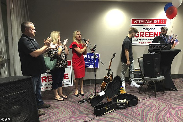 Greene (pictured center) beat neurosurgeon John Cowan in a primary runoff for the open seat  in northwest Georgia. During her victory speech, which was shared on Facebook, Greene calls Democratic House Speaker Nancy Pelosi a 
