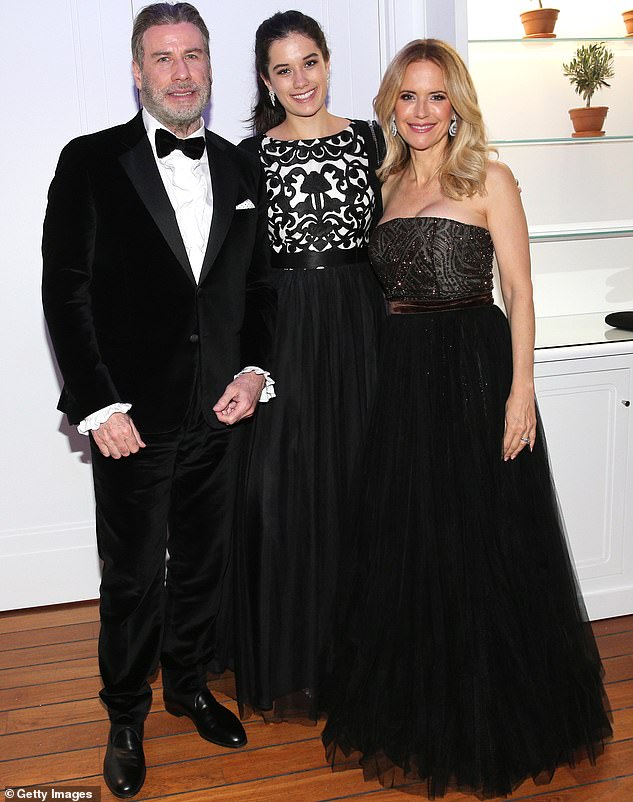 Throwback: Kelly and John were married from 1991 until she died tragically aged 57 of cancer last month at the family home in Florida; the couple are pictured with Ella at Cannes in 2018
