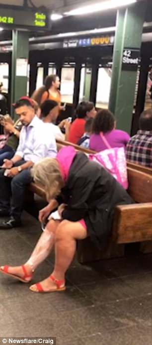 In the unusual footage a seemingly normal woman takes a moment to shave her legs while waiting for a subway car at the 42 street station