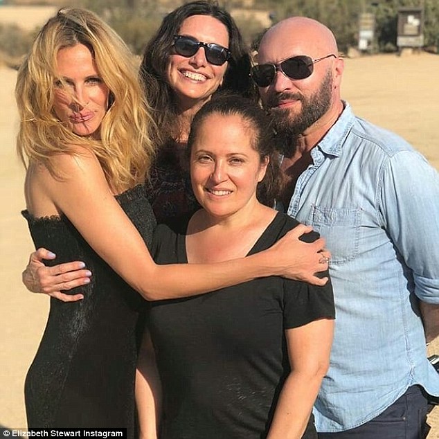 Dream team: In the next image the Runaway Bride star has on a black strapless dress as she puts her arms around two women, stylist Elizabeth Stewart and makeup artist Genevieve Herr. Also seen is Serge again