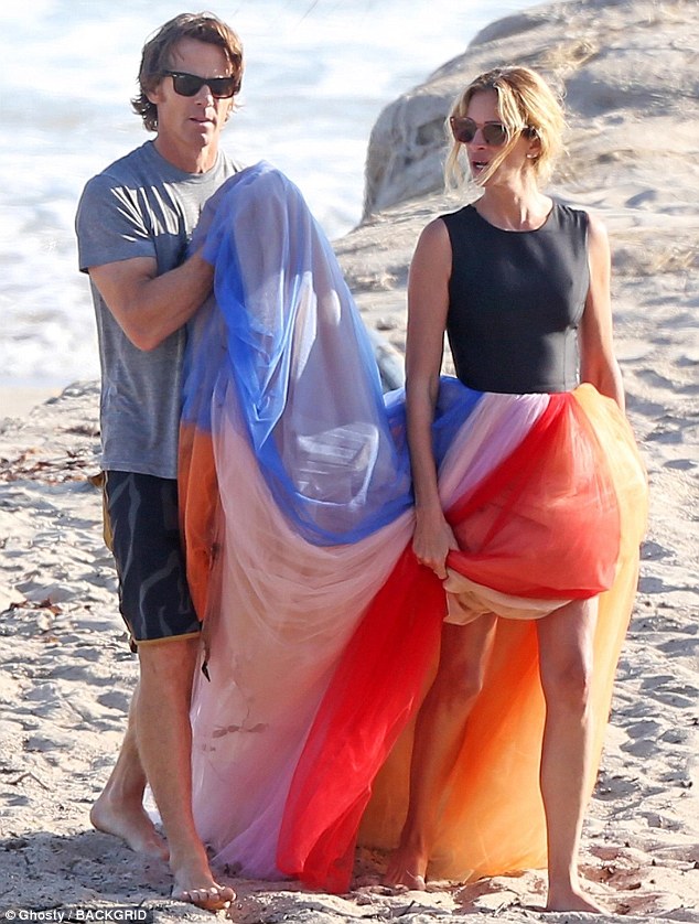 Family matter: Julia Roberts was spotted posing in a colorful dress when on the beach in Malibu on Friday morning. And it appears as if the 50-year-old actress had a little special help from her husband Danny Moder
