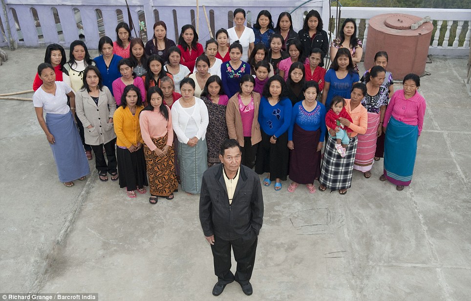 The wives and I: Mr Ziona Chana poses with his 39 wives at their home in Baktawang, Mizoram, India