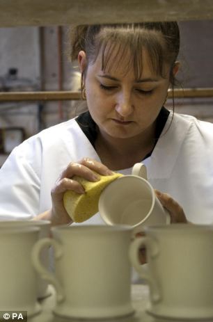 A worker at a pottery in Stoke-on-Trent, Staffordshire works on the new range of Official Royal Wedding Commemorative China for the wedding of Prince William and Kate Middleton