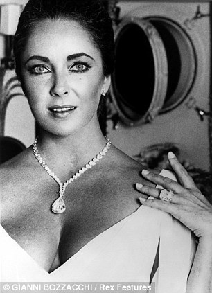 Elizabeth Taylor with a diamond given to her by Richard Burton in 1974. Some of her jewellery and other memorabilia will be sold off at auction