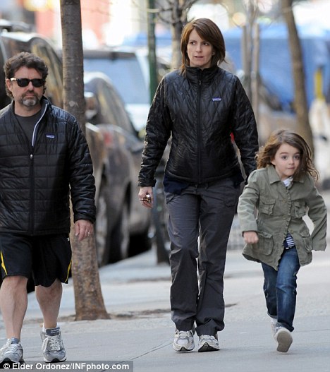 Family outing: Five months pregnant Tina Fey was out for a stroll with husband Jeff Richmond and their daughter, Alice, in New York yesterday