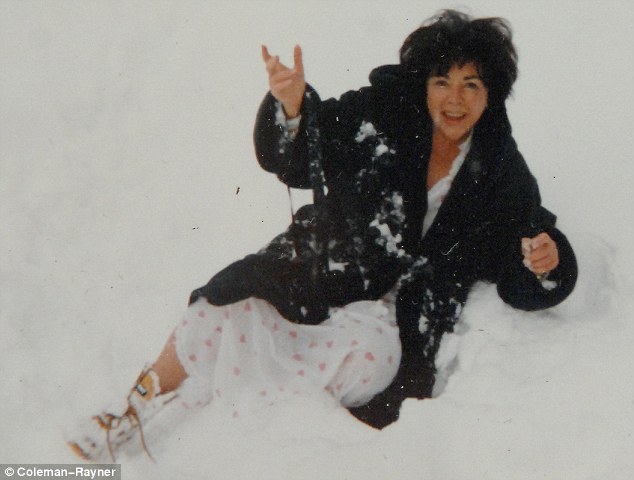 Elizabeth Taylor playing in the snow during a trip with Larry to Switzerland