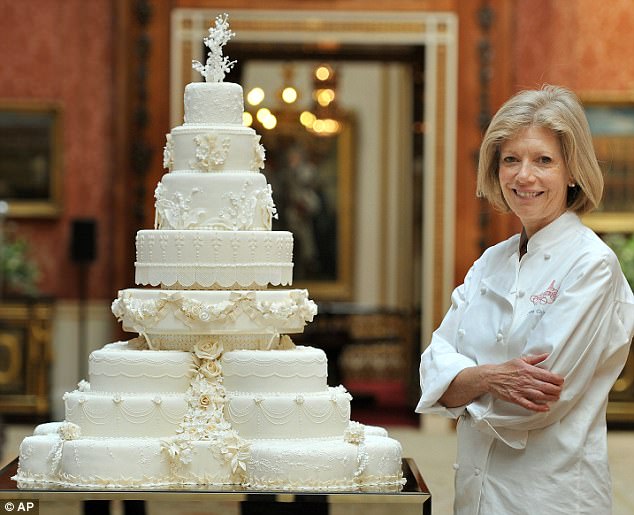 The masterpiece: Fiona Cairns, stands next to the wedding cake that she and her team made for Prince William and his wife Kate, Duchess of Cambridge, in the Picture Gallery of Buckingham Palace