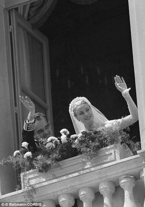 Following their church wedding on April 19, 1956, the real Princess Grace and Prince Ranier wave from a palace window