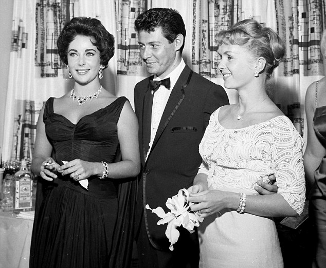 Eddie Fisher poses with his soon-to-be-divorced wife Debbie Reynolds, as well as, his soon-to-be-next wife Elizabeth Taylor at the Tropicana Hotel  in Las Vegas in 1957