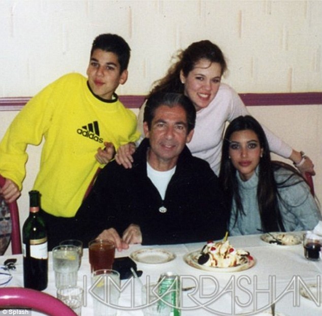 Fun times: Kim posted this  image of her late father with Rob, Khloe and herself on her website