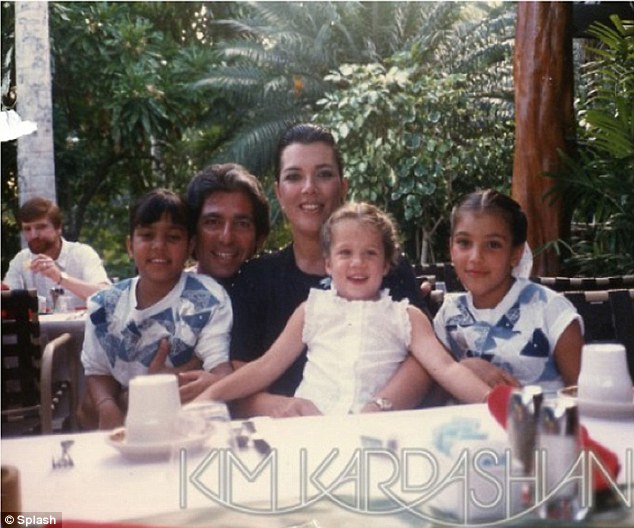 Happier times: Kim posted this image of her late father Robert with Kris, Kourtney and herself via her official website on Father