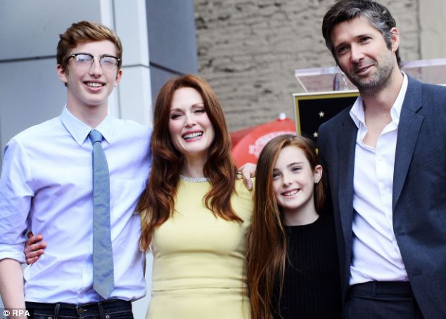 In an exclusive interview with the Mail On Sunday four-time Oscar nominee  Julianne Moore said she and her husband Bart Freundlich, right, keep tabs on their children Caleb, 16, left, and Liv, 12, second from right, online