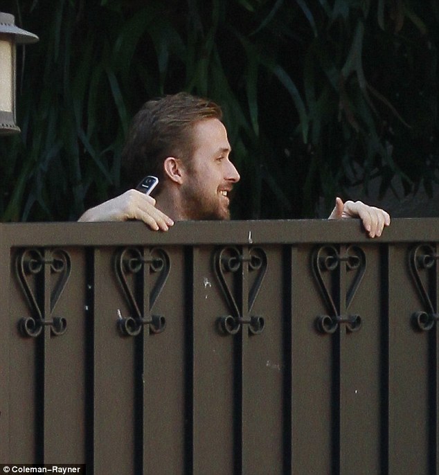 Crazy Stupid Love? Ryan Gosling peers over from behind girlfriend Eva Mendes