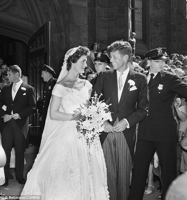 Wedding belle: Senator John F. Kennedy and Jacqueline Lee Bouvier, leave a Newport, Rhode Island, church following their wedding ceremony in 1953. An estimated one thousand people waited outside the church for the newlyweds. One of them was Bobby Kennedy, who would eventually become Jackie