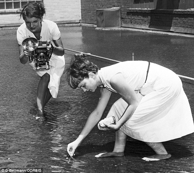 Go Fish: The future first Lady photographs Dale Chestnut feeding goldfish on the roof-top pond of the Washington Times-Herald building
