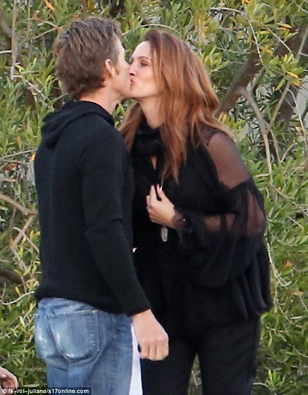 Kissing the Pretty Woman: Julia Roberts gave and husband Danny Moder a tender smooch  as she stepped out with nine-year-old daughter Hazel  in Los Angeles on Wednesday