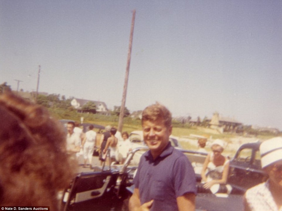 Beach day: US President John F. Kennedy is pictured wearing a casual blue polo shirt as he enjoyed some time in the sun
