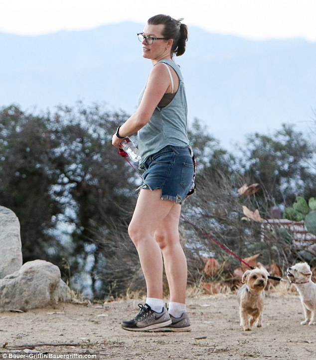 Back in shape sensibly: Milla Jovovich showed off her post pregnancy figure while hiking in LA with her dogs on Friday