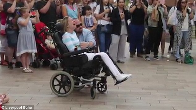 Laura Gilbertson was left in floods of tears after her husband Carl (pictured with Laura) organised a touching flashmob tribute for her to celebrate their tenth anniversary 