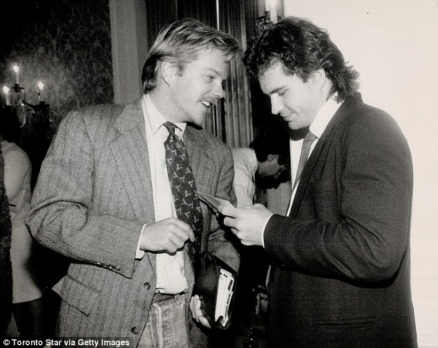 Old pals: Kiefer shows pictures of his then newborn daughter Sarah to Jason Patric in 1988