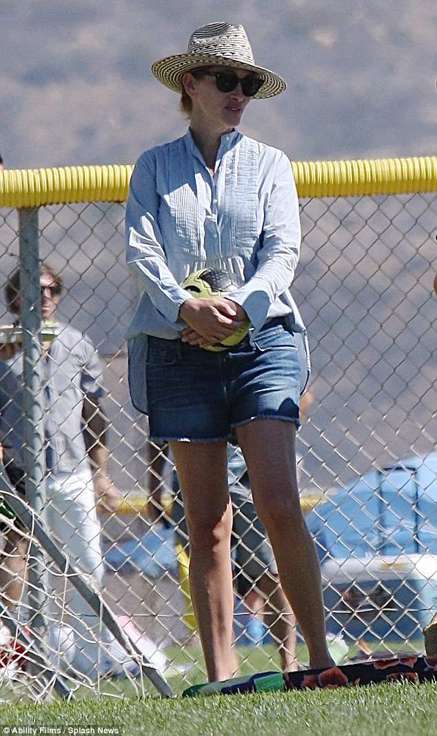 Soccer mom! Julia Roberts covered up beneath a large straw hat and dark over-sized sunglasses in an attempt to stay cool during her kids