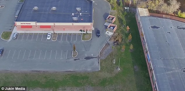 The woman then walks into the parking lot of a nearby CVS before a black car (centre) drives from behind the store to pick her up