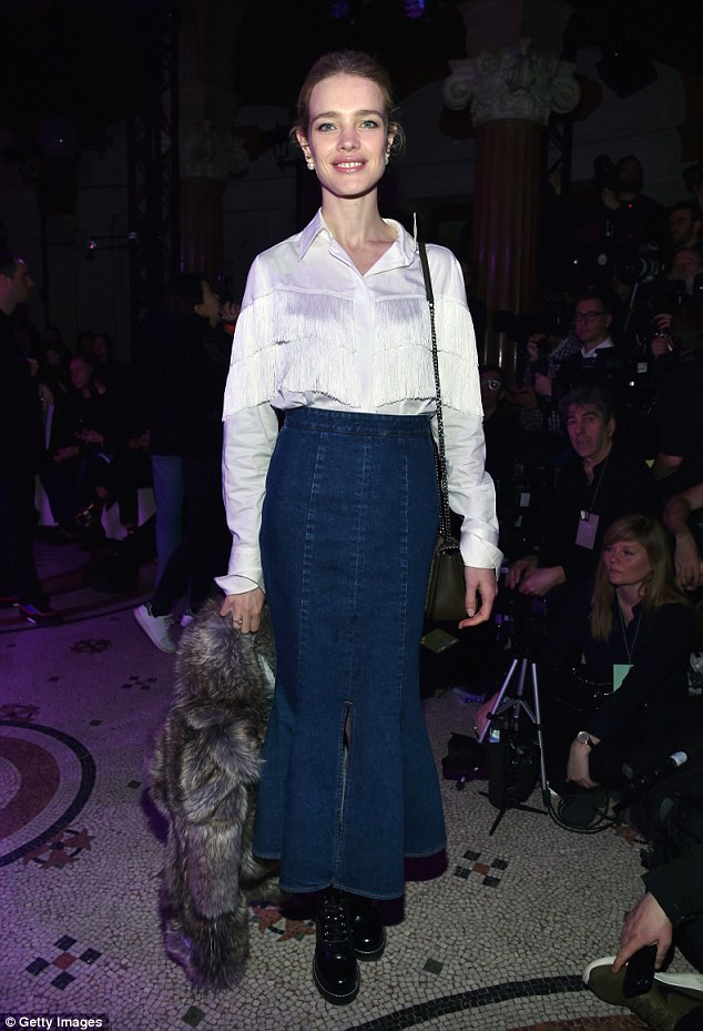 Switching things up: The humanitarian recently hit the FROW in a long denim skirt, a fitted crisp white fringed shirt and chunky Dr Marten black boots 