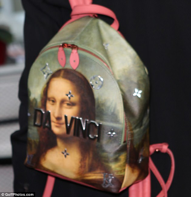 Making a statement! The model-activist carried a statement bag by Louis Vuitton with  the face of the Mona Lisa and metal letters that spelled 