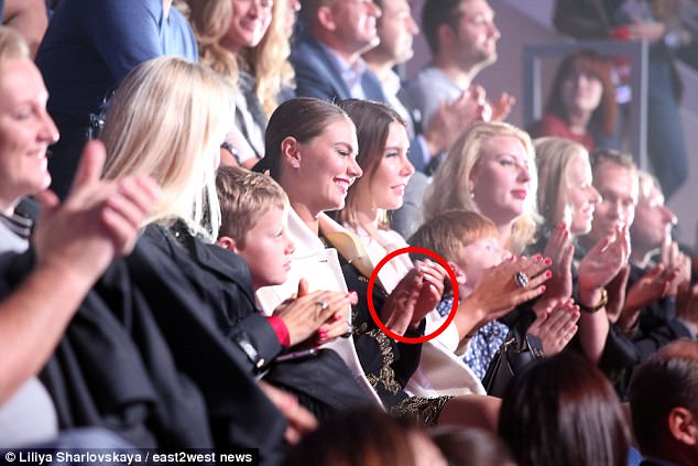 The glamorous former gymnast has been wearing a ring for years, prompting speculation she is with the Russian leader. She is pictured here back in September 2016 at Megasport show in Moscow with a ring (circled) 