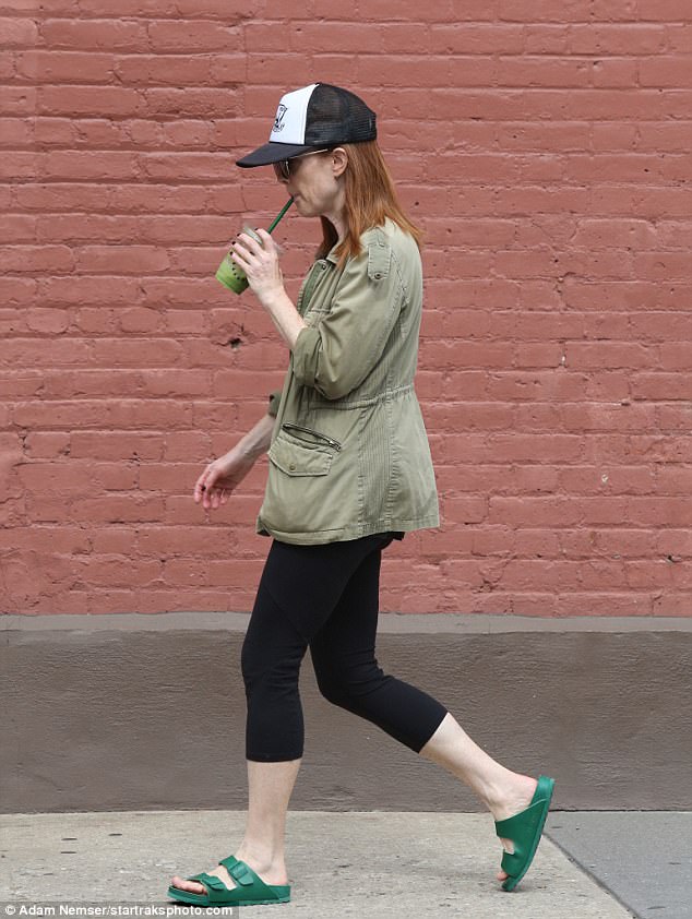 Drink up: The Still Alice actress kept a casual look with her bright green Birkenstock slip-on sandals while sipping on her smoothie