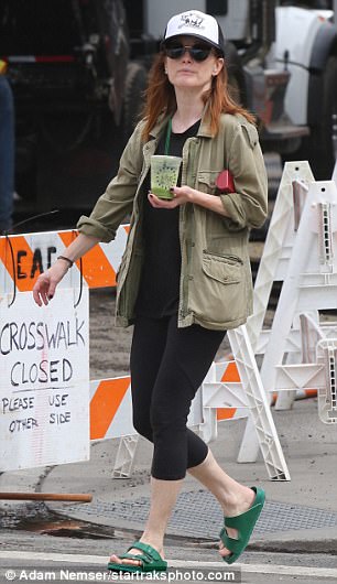Simple: Julianne wore skin-tight workout pants, a black T-shirt and an olive green jacket for her early morning walk