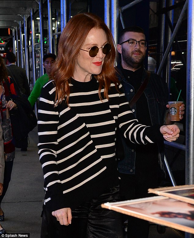 All smiles: Julianne teamed her black silk wide-leg pants with a black and white striped long-sleeved sweater