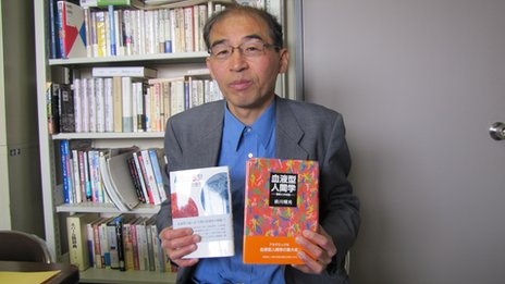 Maekawa holding two of his books