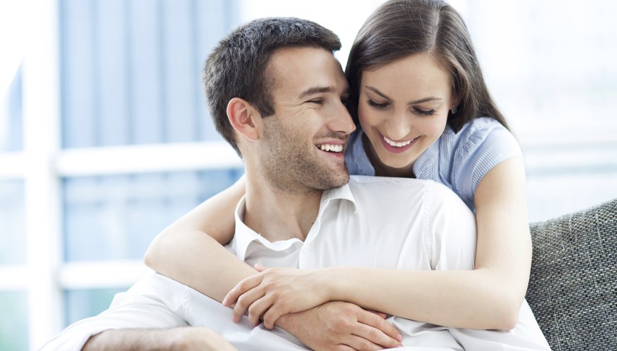 Smiling newlywed couple in apartment