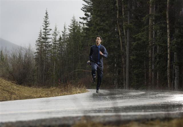Athlete Running In The Rain