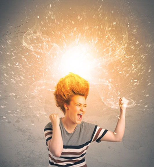 woman in shirt with hair bursting with energy
