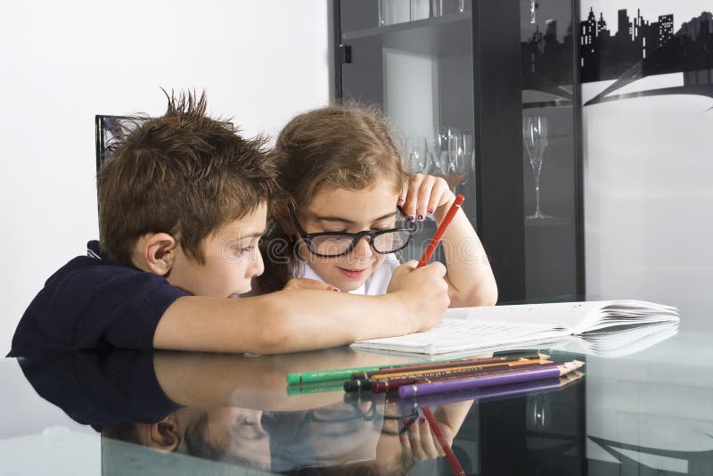 Brother and sister. Doing school homework royalty free stock image