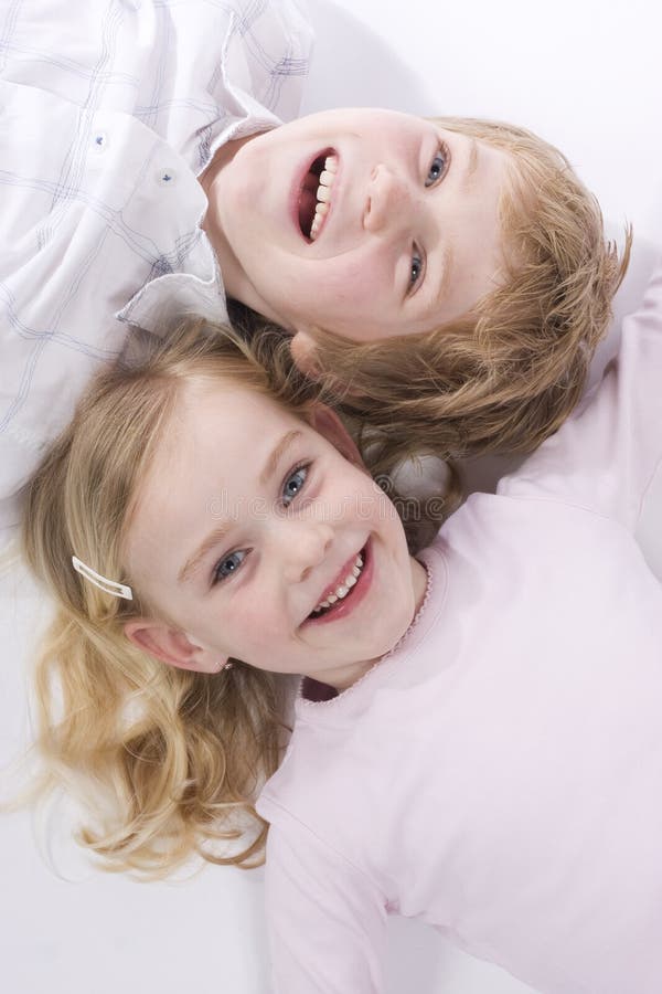 Brother and sister. Both blond hair and blue eyes royalty free stock photography