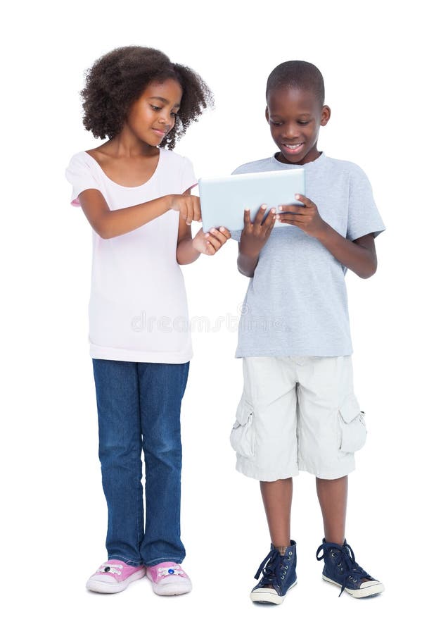 Brother and sister using tablet pc. On a white background royalty free stock photography
